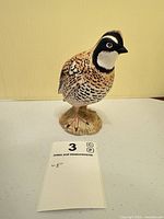Front view of Beswick bobwhite quail figurine showing detail and size card