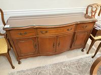 Front view of wooden buffet credenza with glass top