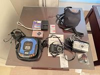 Overview of all electronics, cameras, accessories on table