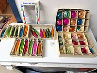 Three boxes of assorted glass ornaments: two boxes of elongated teardrops, one box of round balls