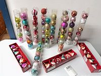 Full lot showing tubes of ball ornaments and boxed cupcake ornaments