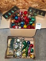 Box of assorted round ornaments and two boxed sets of teal ornaments
