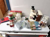 Overall lot showing figurines, ornament packs, LED tapers, assorted decorations