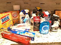 Wide view of assorted cleaners on countertop showing brands and containers