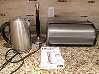 Kettle, bread box, paper towel holder, manual on countertop