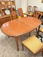 Oval wood dining table with chairs around