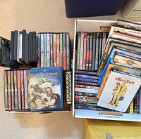 Open box showing large quantity of DVD and Blu-ray cases