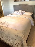 overall view of bed with comforter and pillows