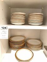 Stacks of Elizabethan plates on cabinet shelves