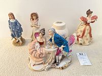 Group shot of all five figurines and Lenox jar
