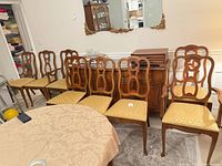 Full set of eight chairs around table, showing style and upholstery