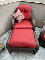 Armchair with red cushions, ottoman, accent pillow