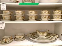 Shelved set showing cups, saucers, plates, tray
