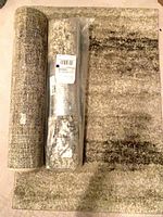 Three mats: one sealed, one rolled, one flat