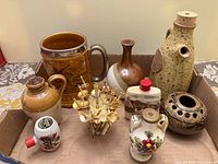 Group shot of all pottery pieces and cocktail sword set