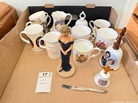 Overall lot showing six mugs, Diana figurine, commemorative bell and knife