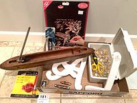 Overview of entire lot showing weaving shuttle, copper foil kit, knives, scissors, glass stones, letters and packaged tool