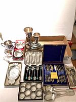 Group shot of all silverplate flatware and serveware