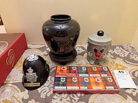 Group shot: vase, Dusty Bin coin bank, police helmet coin bank, boxed matches