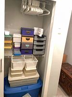 Full closet view showing hangers, fabric boxes, drawer units, baskets and totes