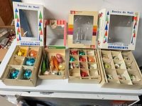 Overview of four open boxes and additional empty packaging on table