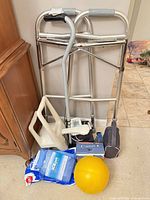 Group shot showing walker, cane, bath seat, BP monitor, orthopedic boot, gel packs and ball