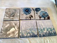 All six canvas prints arranged in two rows on bed