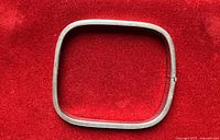 Full view of square sterling silver bangle on red background
