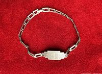 Full view of sterling silver ID bracelet laid flat showing link style and central plaque