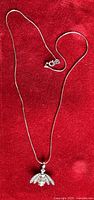 Full view of sterling silver snake chain with bee pendant
