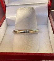 Ring in jeweller's display slot showing diamond accent