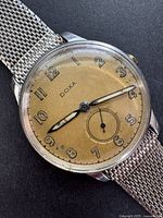 Front view of Doxa watch showing dial, case and mesh bracelet