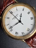 Front view showing dial, hands, numerals and date
