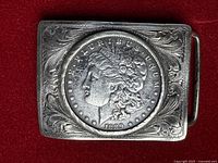 Front view of sterling buckle showing 1889 Morgan dollar and scroll engraving