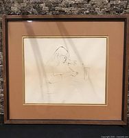 Framed drawing with brown mat showing signed minimalistic figure, full view