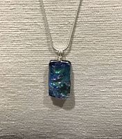 Close-up of pendant front displaying iridescent glass detail