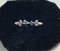 Front view of gold vermeil ring with three blue topaz stones