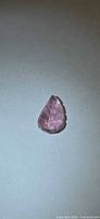 Front view of pear-shaped carved pink tourmaline