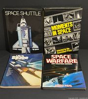 Front covers of all four books displayed upright