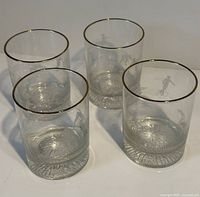 Four etched lowball glasses with gold rims