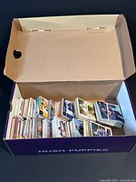 Box containing numerous stacks of hockey cards