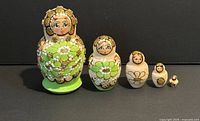 Front view of five wooden nesting dolls