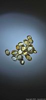 Group of oval golden citrine cabochons under spot lighting
