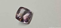 Top view of cushion cut ametrine showing colour zoning and faceting