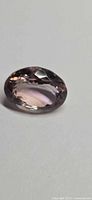 Faceted oval ametrine showing bicolour zoning and facets