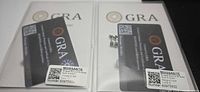 two GRA certification cards and earrings displayed