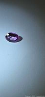 Top view of hot pink oval topaz