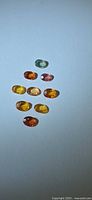Group of nine oval sapphires assorted colors
