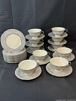 Stacked dessert plates, saucers, and tea cups showing pattern
