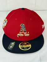Front view showing red crown, black bill, American flag "A" logo, size sticker